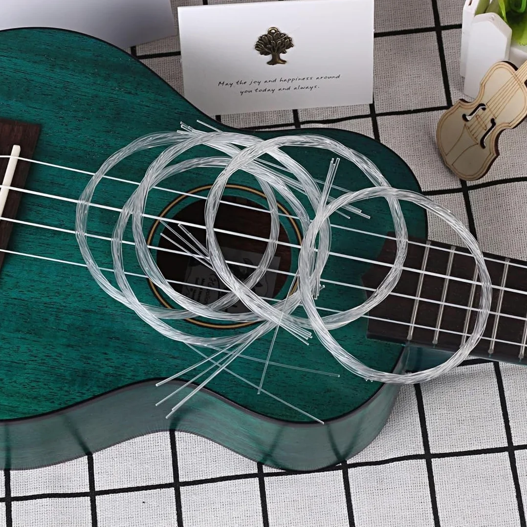 2 zestawy strun nylonowych z 4 strunami w zestawie, na koncert/sopran/ukulele tenorowe, lekkie, z kostkami celuloidowymi